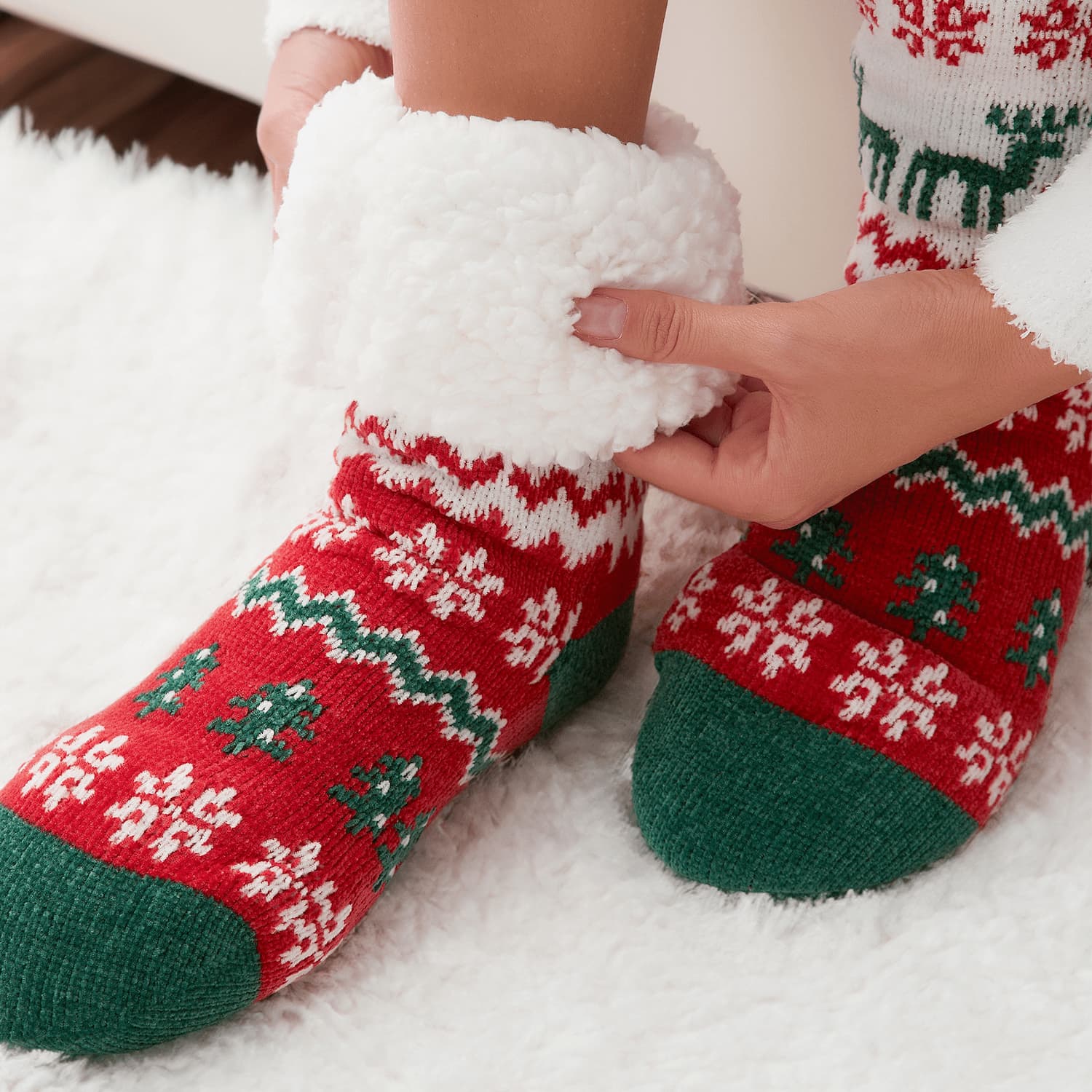 The Foozie™ Christmas Winterland slipper socks, close-up of a hand holding the thick sherpa cuff open