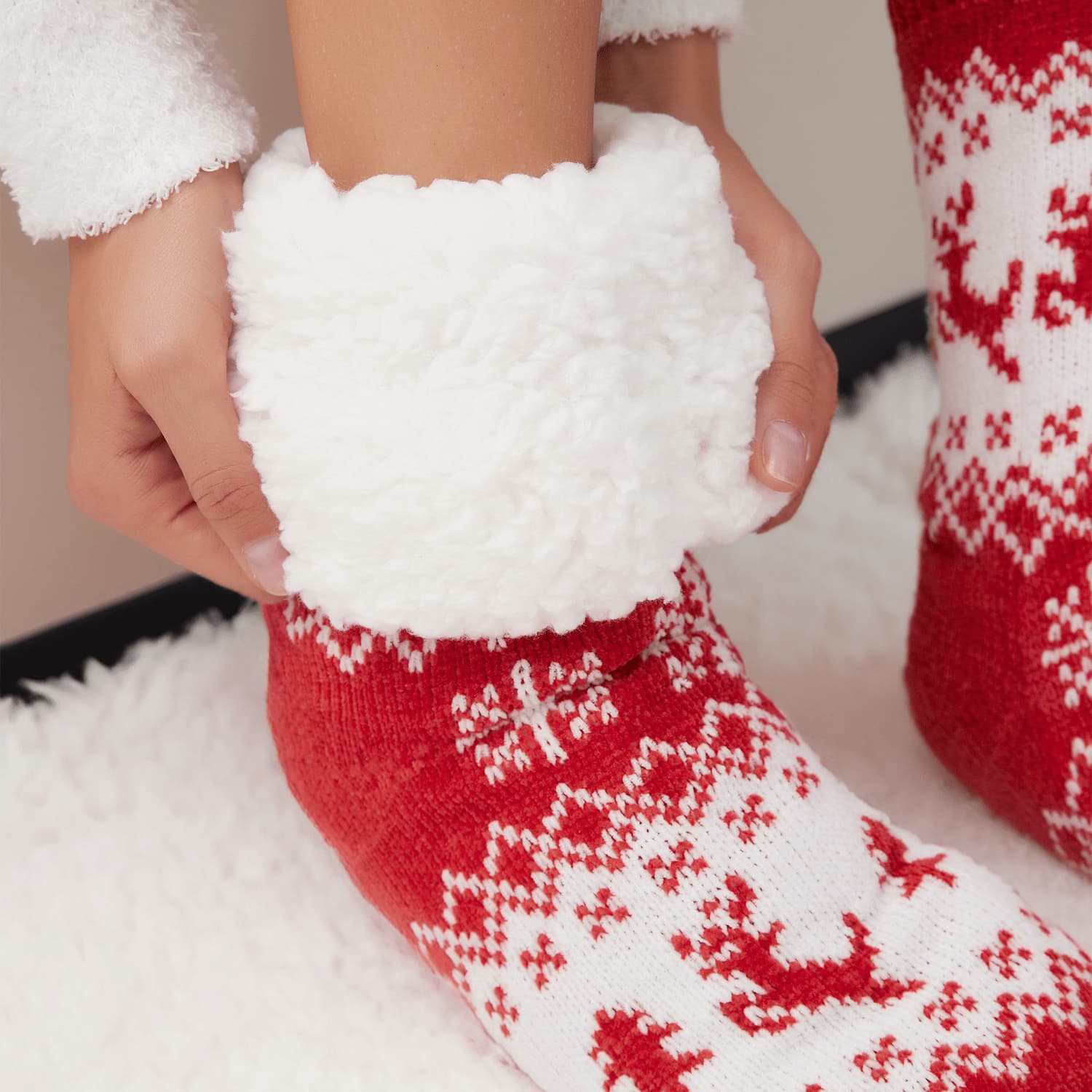 The Foozie™ Christmas Reindeer slipper socks, close-up of hands holding the thick sherpa cuff open